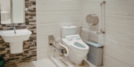 Accessible bathroom with grab rails, shower chair and step free shower, showcasing NDIS assistive technology that supports safe and independent daily living.