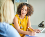 Female GP speaking with a patient, providing ongoing care and supporting NDIS evidence and referrals.