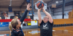 Mildura Basketball for All player shoots for the hoop while a Lifely support worker defends.