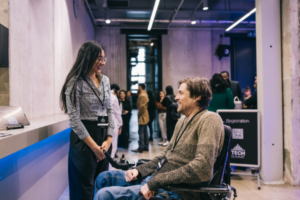 NDIS provider worker helps a man with disability with registration process.